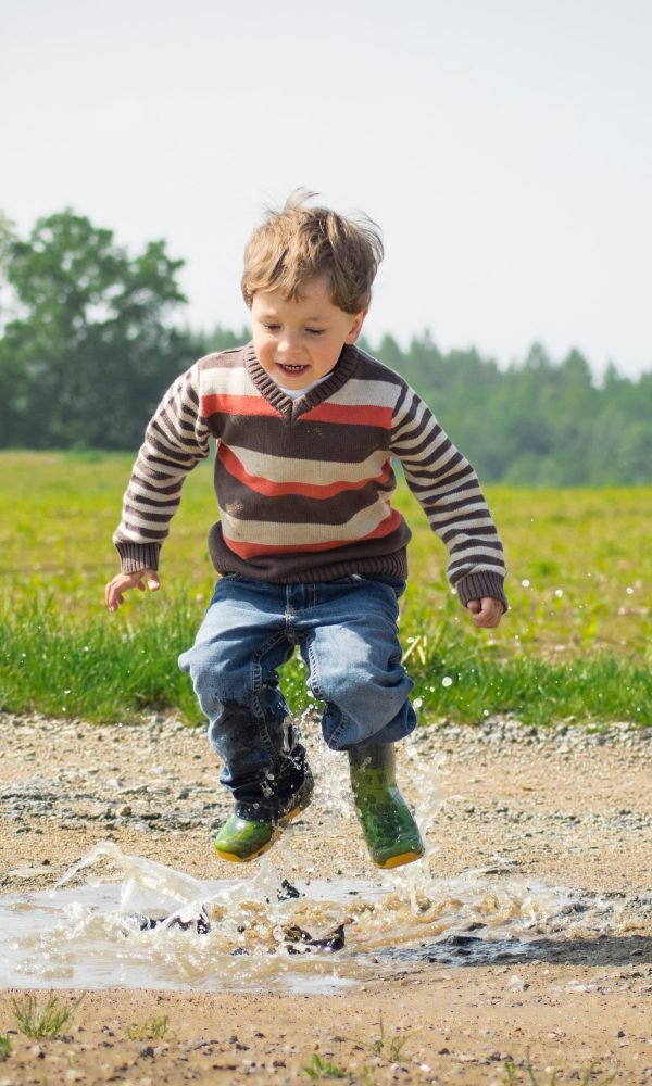 Boy jumping near grass at daytime 1104014 1 600x1000