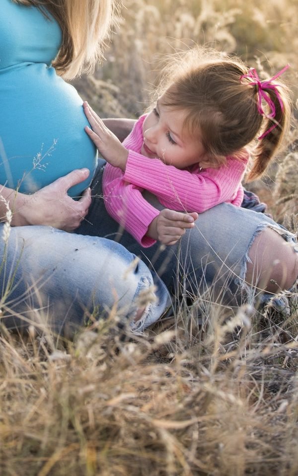 Child touching his mother lamb 160624 600x958