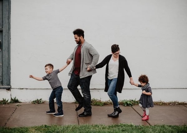 Family of four walking at the street 2253879 600x427